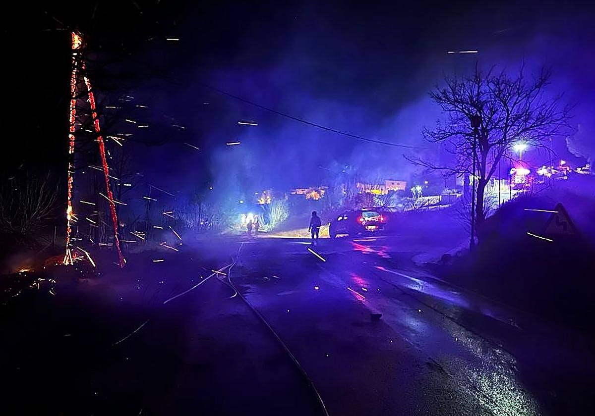 Firefighters work on a vegetation fire near the urban area of Cieza